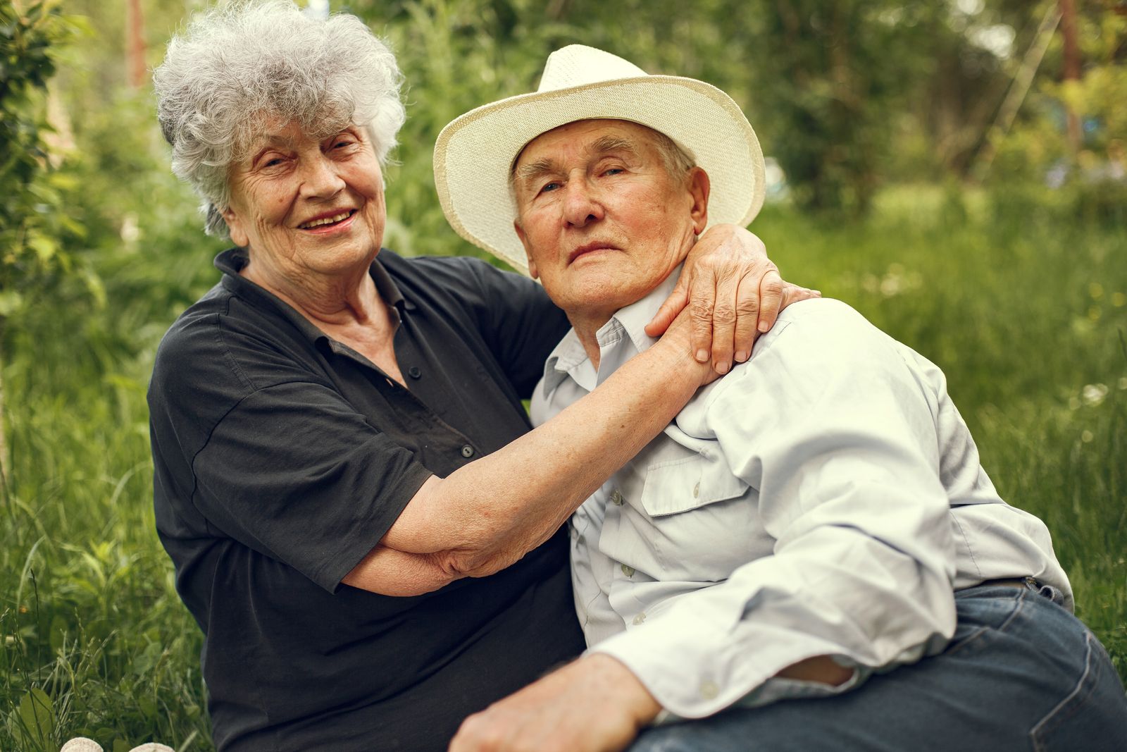 Elderly couple embracing outdoors, secure about the future