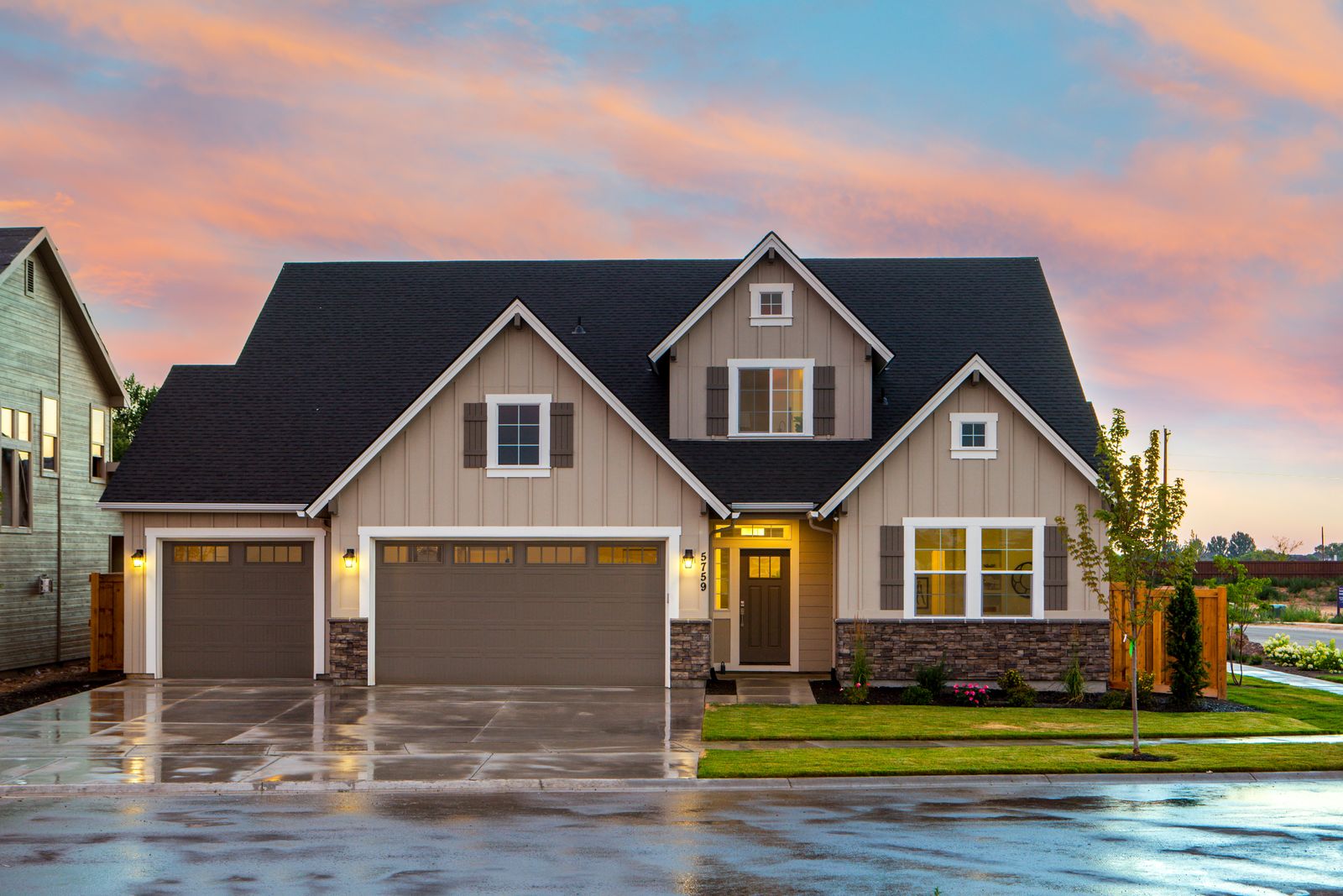 Charming suburban home at dusk with warm lights on